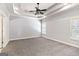 Unfurnished main bedroom with tray ceiling, neutral carpet, and a large window at 230 Hummingbird Ct, Hampton, GA 30228