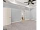 Unfurnished main bedroom with tray ceiling, neutral carpet, and a large window at 230 Hummingbird Ct, Hampton, GA 30228