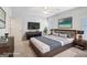 Virtually staged bedroom featuring a large bed, stylish decor, and a mounted TV at 230 Hummingbird Ct, Hampton, GA 30228