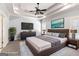 Staged main bedroom featuring a tray ceiling, soft carpet, and coordinated furniture at 230 Hummingbird Ct, Hampton, GA 30228