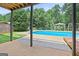 Backyard pool area featuring a patio, lush greenery, a gazebo and a swing set at 230 Hummingbird Ct, Hampton, GA 30228