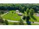 Aerial view of property with lush greenery, pond, solar panels, and long driveway at 4335 Hurt Bridge Lane, Cumming, GA 30028