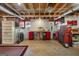 Basement space with exposed ceilings, a workbench, storage units, and carpet at 4335 Hurt Bridge Lane, Cumming, GA 30028