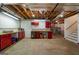 Basement features unfinished ceilings, red cabinets, shelving, and a drop light at 4335 Hurt Bridge Lane, Cumming, GA 30028