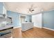 A blue bedroom features a murphy bed, ceiling fan, hardwood floors, and white board and batten ceilings at 4335 Hurt Bridge Lane, Cumming, GA 30028
