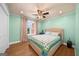 A bedroom features a queen bed with a geometric quilt and hardwood floors at 4335 Hurt Bridge Lane, Cumming, GA 30028