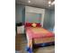 Bedroom features a pull down murphy bed with a bright colorful quilt and a wood floor at 4335 Hurt Bridge Lane, Cumming, GA 30028