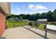 Large deck with cable railings offers scenic views of the backyard, solar panels, and additional garages at 4335 Hurt Bridge Lane, Cumming, GA 30028
