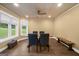 Bright dining room with hardwood floors, a modern ceiling fan, and views of the landscaped yard at 4335 Hurt Bridge Lane, Cumming, GA 30028