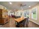 Bright dining room featuring a wooden table, stylish chairs, and large windows overlooking the backyard at 4335 Hurt Bridge Lane, Cumming, GA 30028