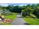 Long driveway leading to house, shed, and solar panels, set against a backdrop of lush greenery at 4335 Hurt Bridge Lane, Cumming, GA 30028