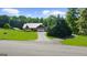Charming single-story home features a metal roof, an attached garage, manicured lawn and solar panels for energy efficiency at 4335 Hurt Bridge Lane, Cumming, GA 30028