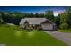 Charming single-story home features a metal roof, an attached garage, manicured lawn and solar panels for energy efficiency at 4335 Hurt Bridge Lane, Cumming, GA 30028