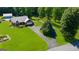 Charming single-story home with a metal roof, an attached garage and a pond on the property, plus a manicured lawn at 4335 Hurt Bridge Lane, Cumming, GA 30028