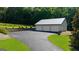 Detached garage with three bays and paved driveway, surrounded by well-manicured lawn and landscaping at 4335 Hurt Bridge Lane, Cumming, GA 30028