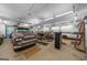 Spacious garage interior featuring multiple cars, storage, and ample lighting at 4335 Hurt Bridge Lane, Cumming, GA 30028