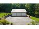 Detached three-car garage with long driveway, offering ample parking and storage space at 4335 Hurt Bridge Lane, Cumming, GA 30028