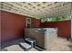 A lovely covered hot tub with steps situated on a brick patio, offering a relaxing outdoor experience at 4335 Hurt Bridge Lane, Cumming, GA 30028