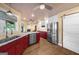 A spacious kitchen featuring stainless steel appliances, a sliding barn door, and marble countertops at 4335 Hurt Bridge Lane, Cumming, GA 30028