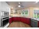 Well-equipped kitchen with stainless appliances, modern vent hood, and open shelving for storage at 4335 Hurt Bridge Lane, Cumming, GA 30028