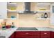 Modern kitchen with marble countertops, open shelving, and a stainless steel vent hood at 4335 Hurt Bridge Lane, Cumming, GA 30028