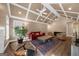 This living room features vaulted ceilings, hardwood floors, ceiling fans, and comfortable furniture at 4335 Hurt Bridge Lane, Cumming, GA 30028
