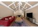 Spacious living room with hardwood floors, vaulted ceilings, a decorative rug, and comfortable seating at 4335 Hurt Bridge Lane, Cumming, GA 30028