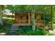 Cozy wooden outbuilding nestled among trees, featuring a covered porch and rustic charm at 4335 Hurt Bridge Lane, Cumming, GA 30028