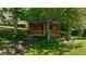Charming wooden outbuilding surrounded by lush greenery and mature trees at 4335 Hurt Bridge Lane, Cumming, GA 30028