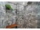 The luxurious tiled shower features stone pebble floor, a rain shower head, and a built-in bench at 4335 Hurt Bridge Lane, Cumming, GA 30028