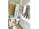 Bathroom featuring a vanity, toilet, tub and shower with tiled surround at 241 Balaban Cir # 241, Woodstock, GA 30188