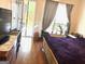Bedroom with outside view, tv, hardwood floors, and gray accents at 241 Balaban Cir # 241, Woodstock, GA 30188
