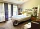 Bedroom with a large window, artwork, mirror, and bedside table at 241 Balaban Cir # 241, Woodstock, GA 30188