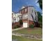 Exterior elevation of a two-story home with red shutters, brick, and siding at 241 Balaban Cir # 241, Woodstock, GA 30188