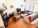 Spacious living room with hardwood floors, fireplace, and ample natural light at 241 Balaban Cir # 241, Woodstock, GA 30188