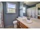 Full bathroom featuring a window, floral tile floors, a wooden cabinet and a single sink at 369 Parker Rd, Mcdonough, GA 30252