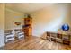 Versatile bedroom displays wood-look floors, natural light, a decorative globe, and space for both relaxation and productivity at 369 Parker Rd, Mcdonough, GA 30252