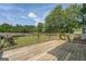 Inviting wooden deck offering scenic views of the expansive backyard with lush greenery and mature trees at 369 Parker Rd, Mcdonough, GA 30252