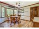 Open dining area with wood floors, a round table, and bay window offering outdoor views at 369 Parker Rd, Mcdonough, GA 30252