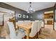 A dining room featuring a wooden table, upholstered chairs, dark walls, and wood floors at 369 Parker Rd, Mcdonough, GA 30252