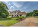 Beautiful home with manicured front lawn and driveway, framed by mature trees at 369 Parker Rd, Mcdonough, GA 30252
