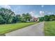 Charming two-story home with red shutters and a welcoming front porch, set on a lush green lawn at 369 Parker Rd, Mcdonough, GA 30252