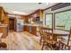 Eat-in kitchen with wood cabinets, stainless steel appliances, and wood-like floors at 369 Parker Rd, Mcdonough, GA 30252