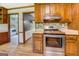 Modern kitchen with stainless steel oven and range, wood cabinets and drawers with a view into the laundry room at 369 Parker Rd, Mcdonough, GA 30252