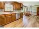 Spacious kitchen featuring wood cabinets, stainless appliances, and an adjacent dining area at 369 Parker Rd, Mcdonough, GA 30252