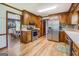 A kitchen with ample wood cabinetry, stainless steel appliances, wood floors and decorative backsplash at 369 Parker Rd, Mcdonough, GA 30252