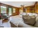 Spacious living room with hardwood floors, wood-paneled walls, and large sectional sofa at 369 Parker Rd, Mcdonough, GA 30252