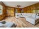 Bright living room with wood floors, paneled walls, ceiling fan, and comfortable seating at 369 Parker Rd, Mcdonough, GA 30252