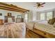 Spacious main bedroom featuring exposed beams, brick fireplace, wood floors and lots of natural light at 369 Parker Rd, Mcdonough, GA 30252