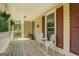 Inviting porch featuring a seating area, decorative plants, and elegant white railings at 369 Parker Rd, Mcdonough, GA 30252